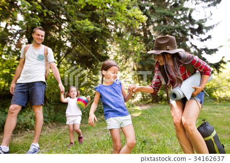 Beautiful young family with daughters going 34162637