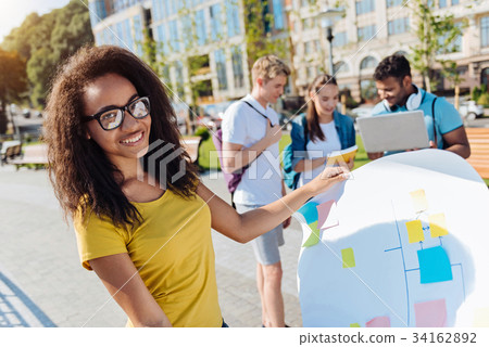 Attractive mulatto holding her project 34162892