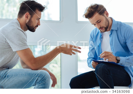Sad bearded man telling about his life Sad bearded man telling about his life 34163098