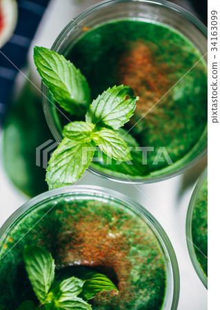 Green smoothies with leaves of fresh mint Green smoothies with leaves of fresh mint 34163099