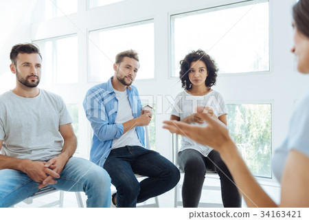 Serious nice therapy group members listening to Serious nice therapy group members listening to 34163421