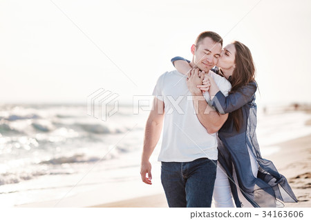 Beautiful young couple on the sandy beach of the 34163606