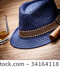 blue hat with cigar and expensive drink whisky rum 34164118