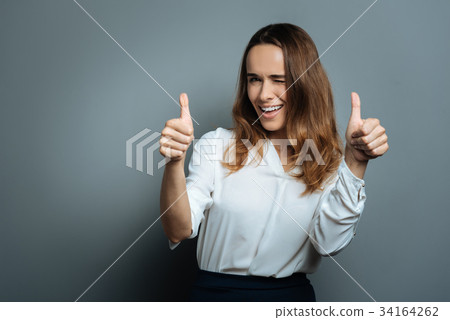 Happy delighted woman showing optimism Happy delighted woman showing optimism 34164262