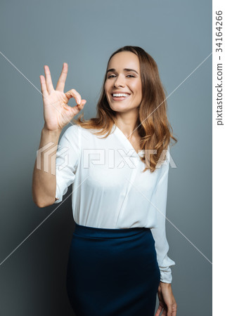 Happy nice woman showing OK gesture Happy nice woman showing OK gesture 34164266