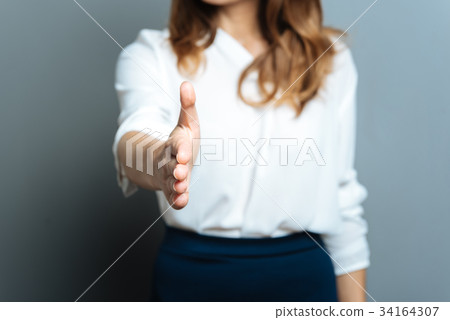 Selective focus of a palm being given to you 34164307