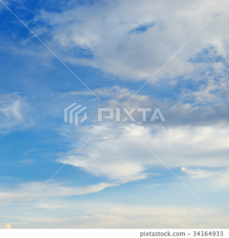 Light cirrus clouds in the blue bright sky. 34164933