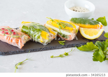 raw spring rolls with vegetables on slate raw spring rolls with vegetables on slate 34165213