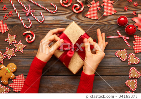 Female hands on christmas gift 34165373