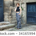 Tall girl with short hair standing 34165994