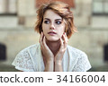 Young beautiful girl in white summer dress 34166004