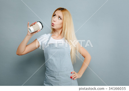 Funny longhaired blonde holding paper cup 34166035