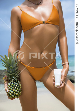 Close-up beautiful luxury slim girl in a swimsuit 34166735