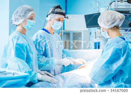 Serious male person standing near his colleagues 34167000