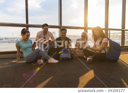 Young People Group Sitting On Floor Airport Lounge Young People Group Sitting On Floor Airport Lounge 34168177