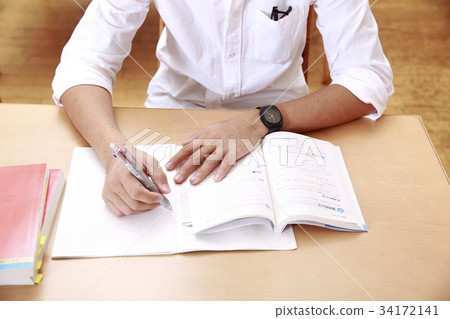 Male student studying for the exam 34172141