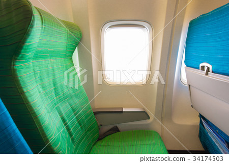 Airplane seat near windows in cabin of aircraft Airplane seat near windows in cabin of aircraft 34174503