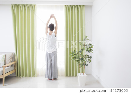 A woman by the window A woman by the window 34175003