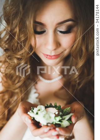Luxury bride in white dress posing while preparing 34178144