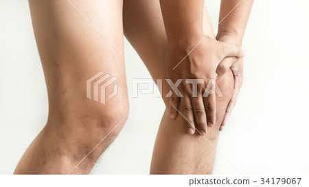 the knee man holds on suffering from pain in knee  34179067