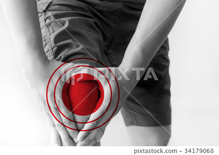 the knee man holds on suffering from pain in knee  34179068