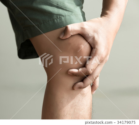 the knee man holds on suffering from pain in knee 34179075