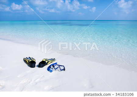 Swimming mask, fins and tube on seashore Swimming mask, fins and tube on seashore 34183106