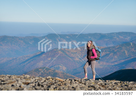 Woman backpacker enjoying the open view on the mountains 34183597