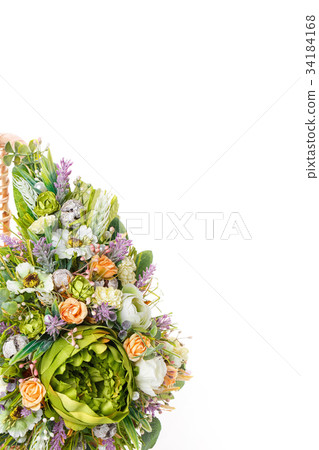 basket with flowers to celebrate Easter on a white 34184168