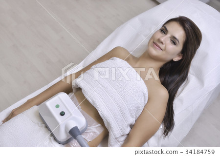Beautiful woman getting cryolipolyse treatment Beautiful woman getting cryolipolyse treatment 34184759