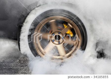 Drag racing car burns tires for the race Drag racing car burns tires for the race 34185855