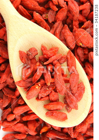 dried goji berries on a wooden spoon 34187238