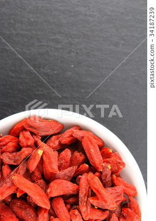 dried goji berries in a small white bowl 34187239