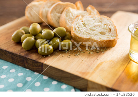 Overhead of marinated olives with glass and bottle of wine Overhead of marinated olives with glass and bottle of wine 34188526