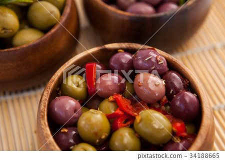 Overhead view of green olive with oil in container 34188665