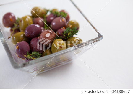 Black and green olive oil in bottle on table 34188667