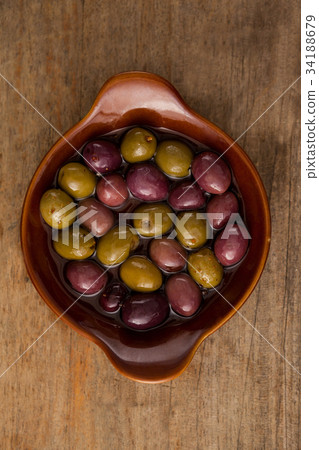 Olives with vegetable and spice by oil in bowl on table Olives with vegetable and spice by oil in bowl on table 34188679