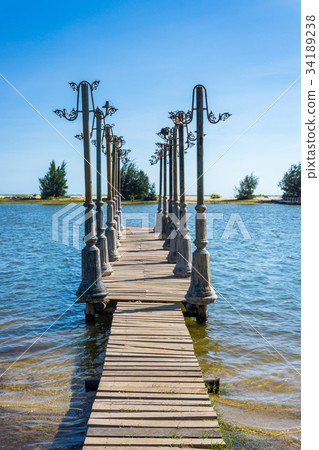 Wood pier and light posts in pond Wood pier and light posts in pond 34189238