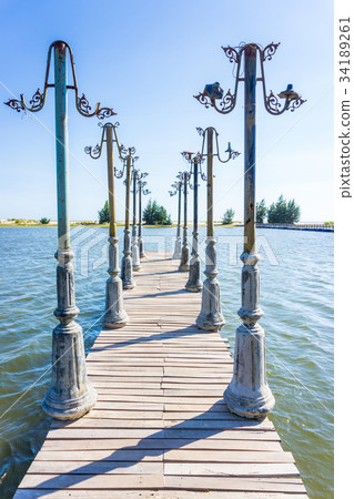 Light posts and wood pier in pond 34189261