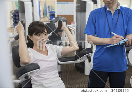 Women doing muscle training in a sports club 34189363