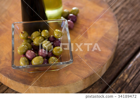 Cocktail martini with olives on table 34189472