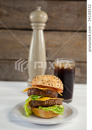 Snacks and cold drink on wooden table 34189532