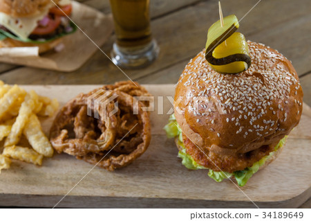 Burger and french fries in plate with glass of beer 34189649