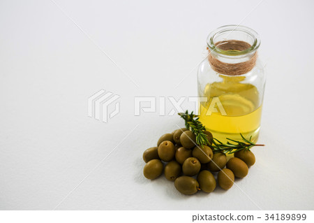 Close-up of marinated olives with glasses of wine 34189899
