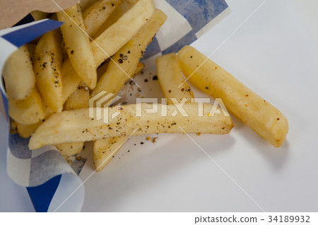 Hamburger and french fries in a take away container on table Hamburger and french fries in a take away container on table 34189932