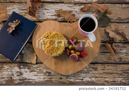 Autumn leaves, black tea and open book on white background 34191732