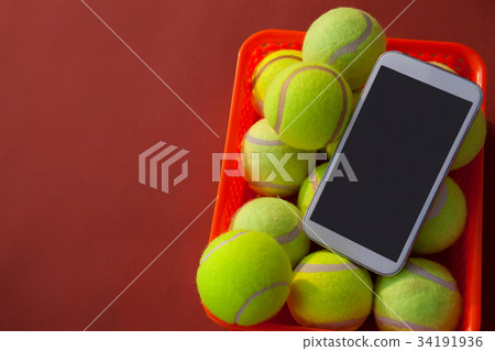 High angle view of gray bag on sports shoes with tennis gear by mobile phone and sunglasses High angle view of gray bag on sports shoes with tennis gear by mobile phone and sunglasses 34191936