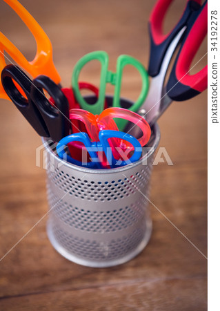 Overhead view of office supplies with camera and artificial tulip flowers 34192278