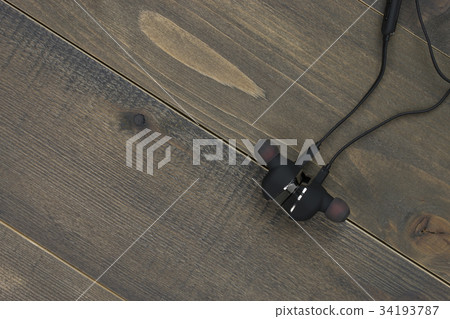 earphones on wood desk with copy space. earphones on wood desk with copy space. 34193787