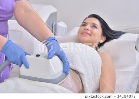 Young woman getting cryolipolyse fat treatment Young woman getting cryolipolyse fat treatment 34194072